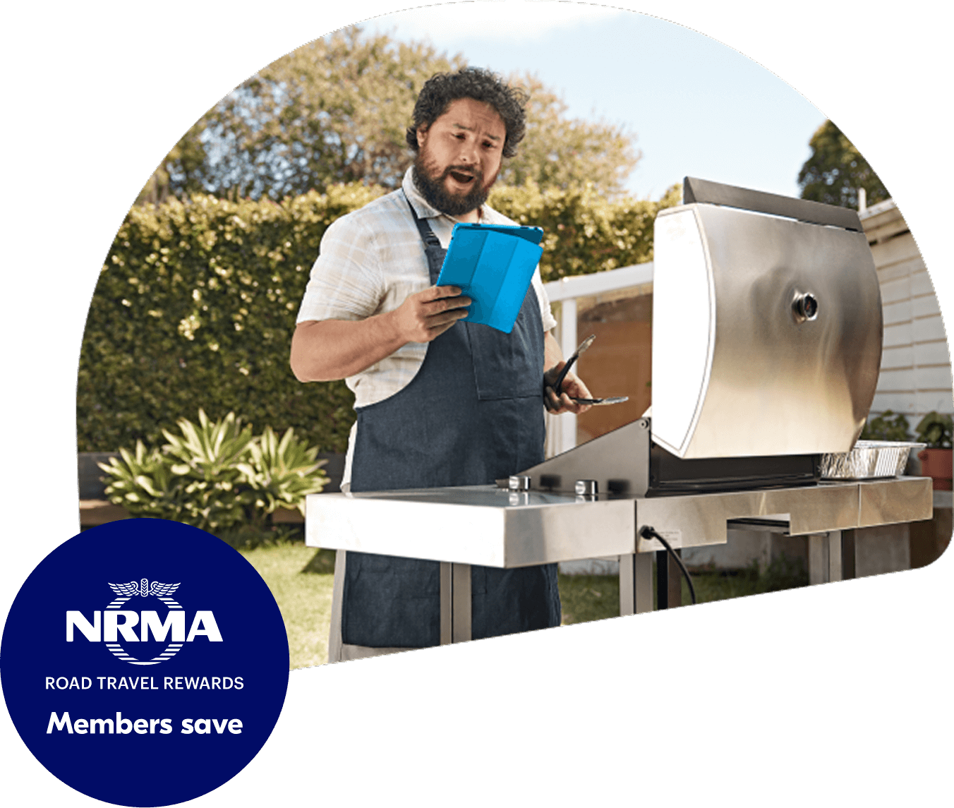 A man using a barbecue while looking at a tablet computer