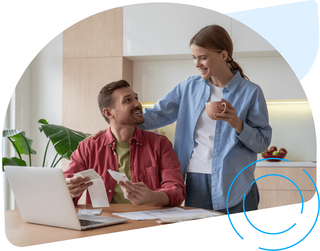 Young couple looking at their laptop in the kitchen