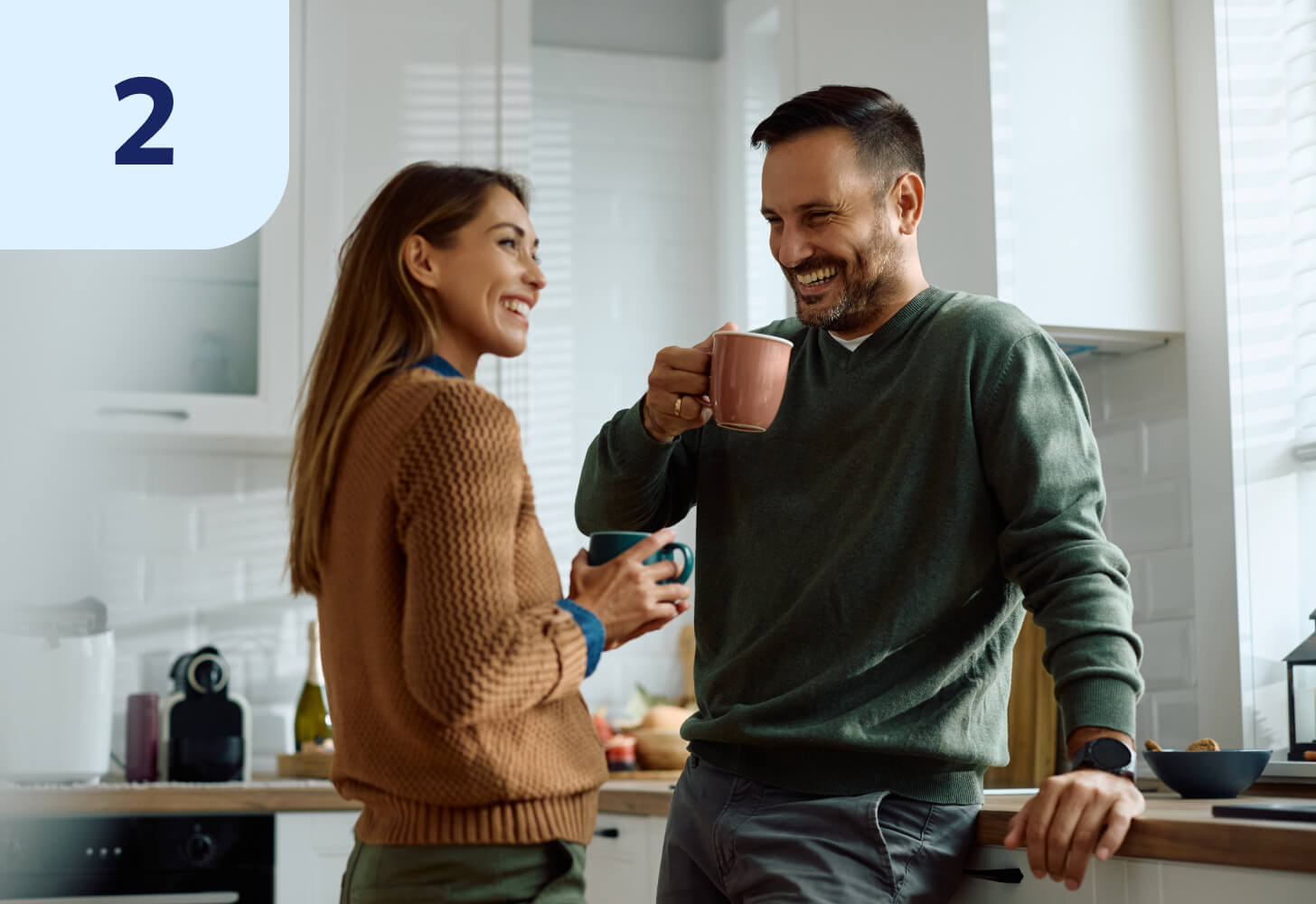 Two people chatting over coffee in a kitchen
