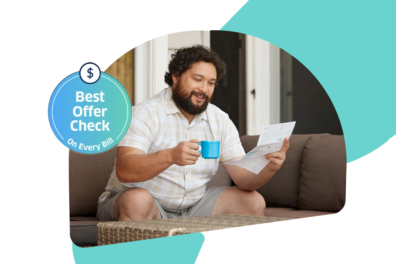 Man sitting on a couch reading a bill
