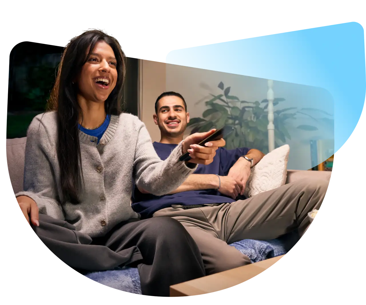 A couple sitting on the couch at home.