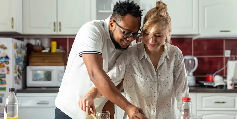 A couple cooking together in the kitchen