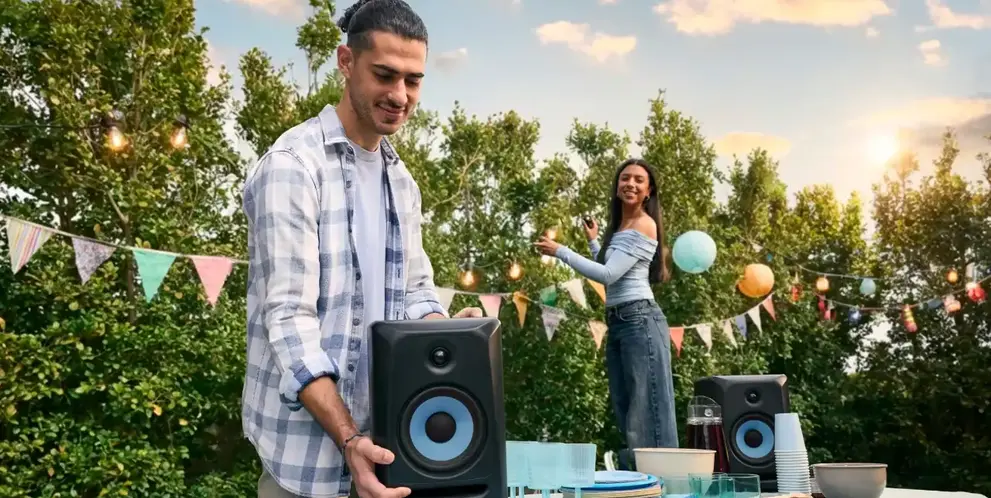 A couple setting up an outdoor house party.