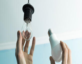 Lightbulb being replaced for energy saving bulb