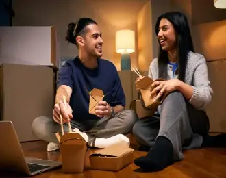 a couple eating a takeaway meal at home.