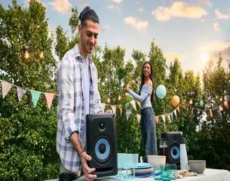 A couple setting up an outdoor house party.