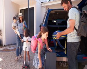 Family packing the car for a holiday