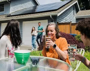 A family gathering in the front yard of their home.